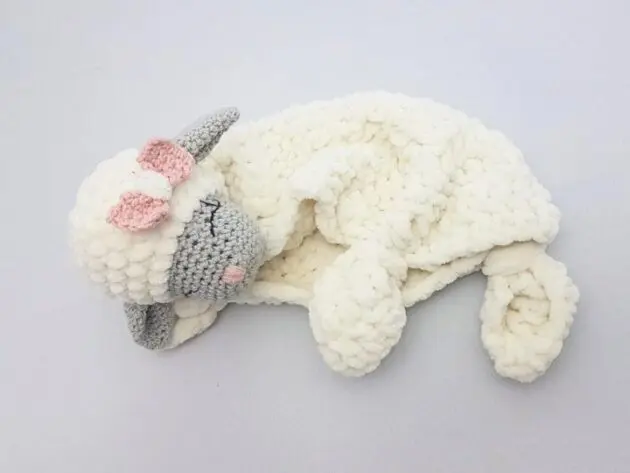 Baby lovey crochet pattern category cover showing a plush lamb lovey in white and gray yarn on a light background