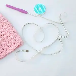 Crochet materials with measuring tape.