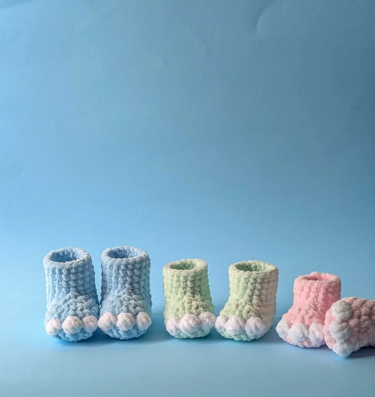 Colorful dinosaur-themed baby booties