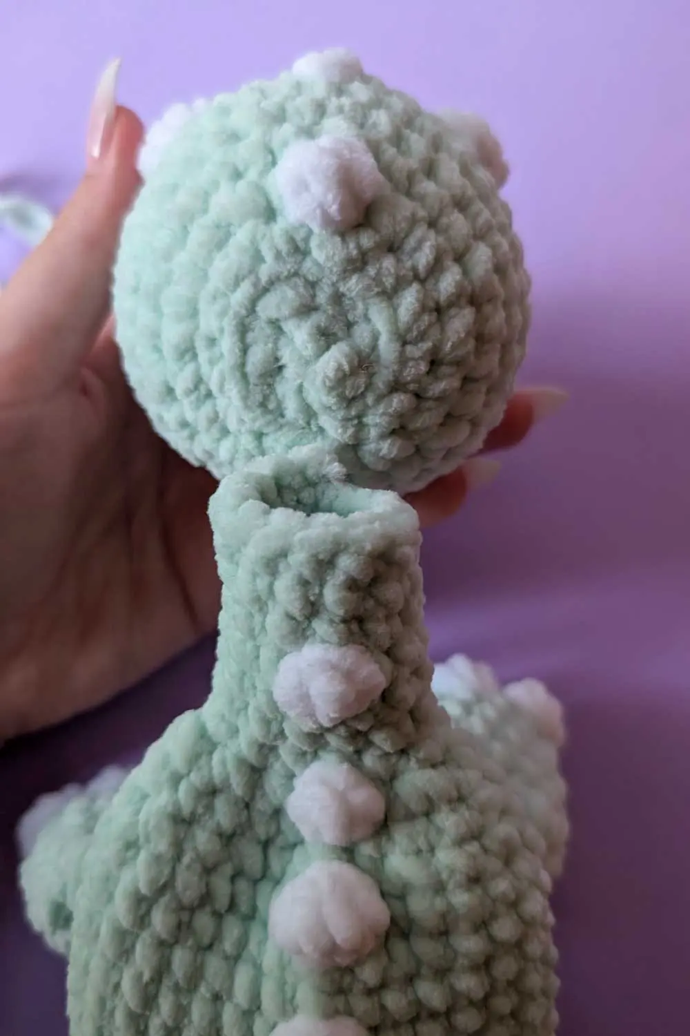 Crocheted dinosaur head and back assembly step image