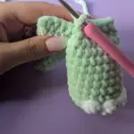 Image showing how to attach legs for a dinosaur lovey
