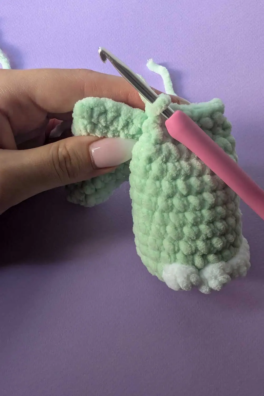 Image showing how to attach legs for a dinosaur lovey