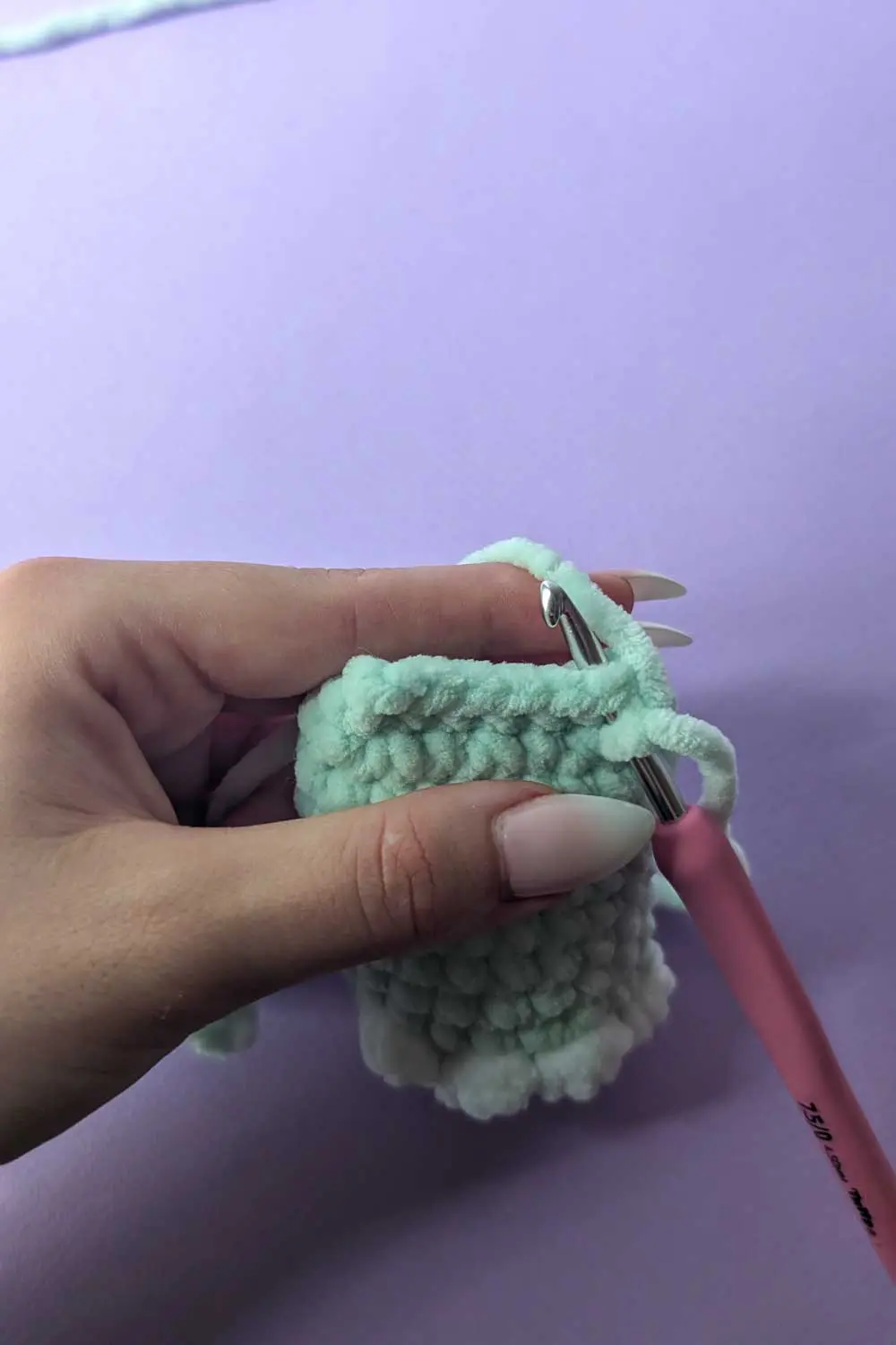 Image showing how to attach legs for a dinosaur lovey