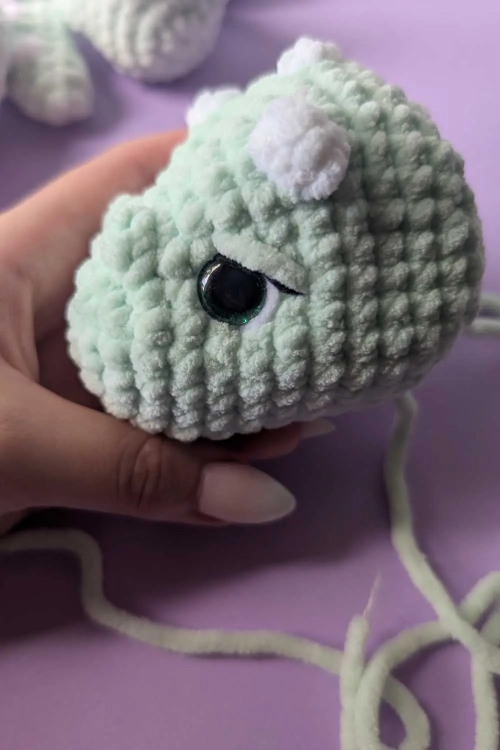 Crocheted dinosaur head in progress embroidery instructions