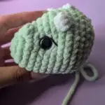 Crocheted dinosaur head in progress embroidery instructions