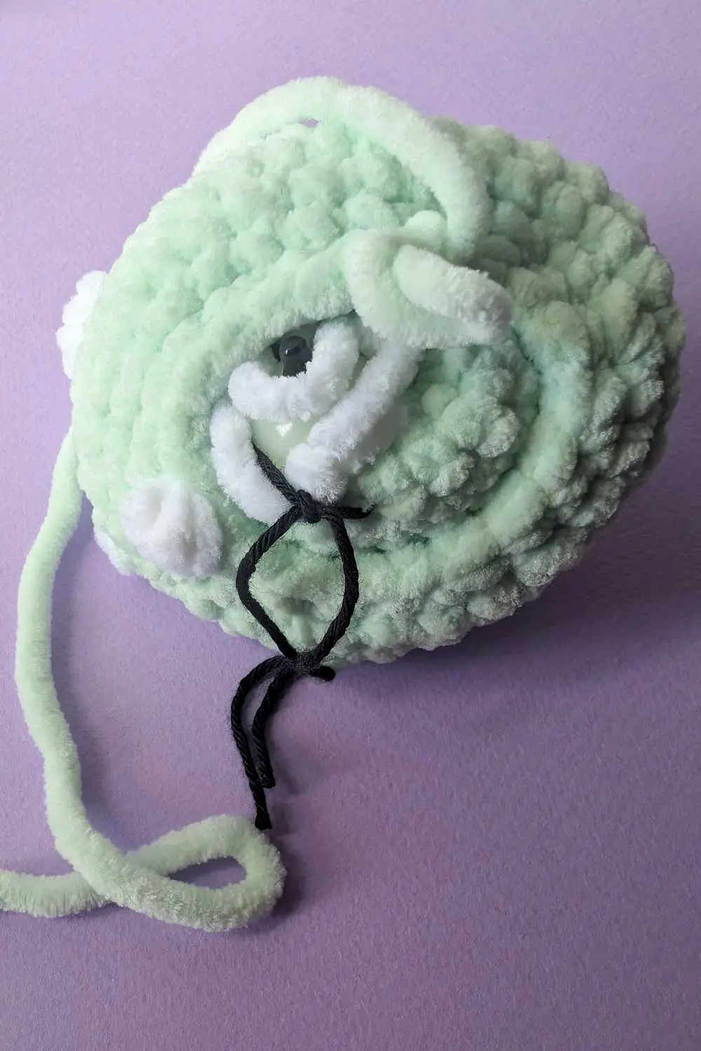 Crocheted dinosaur head in progress embroidery instructions