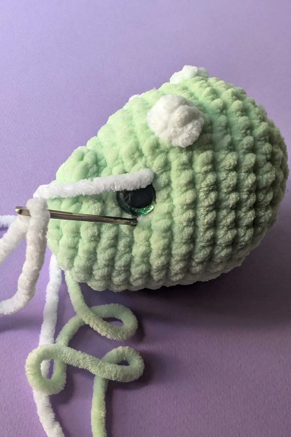 Crocheted dinosaur head in progress embroidery instructions