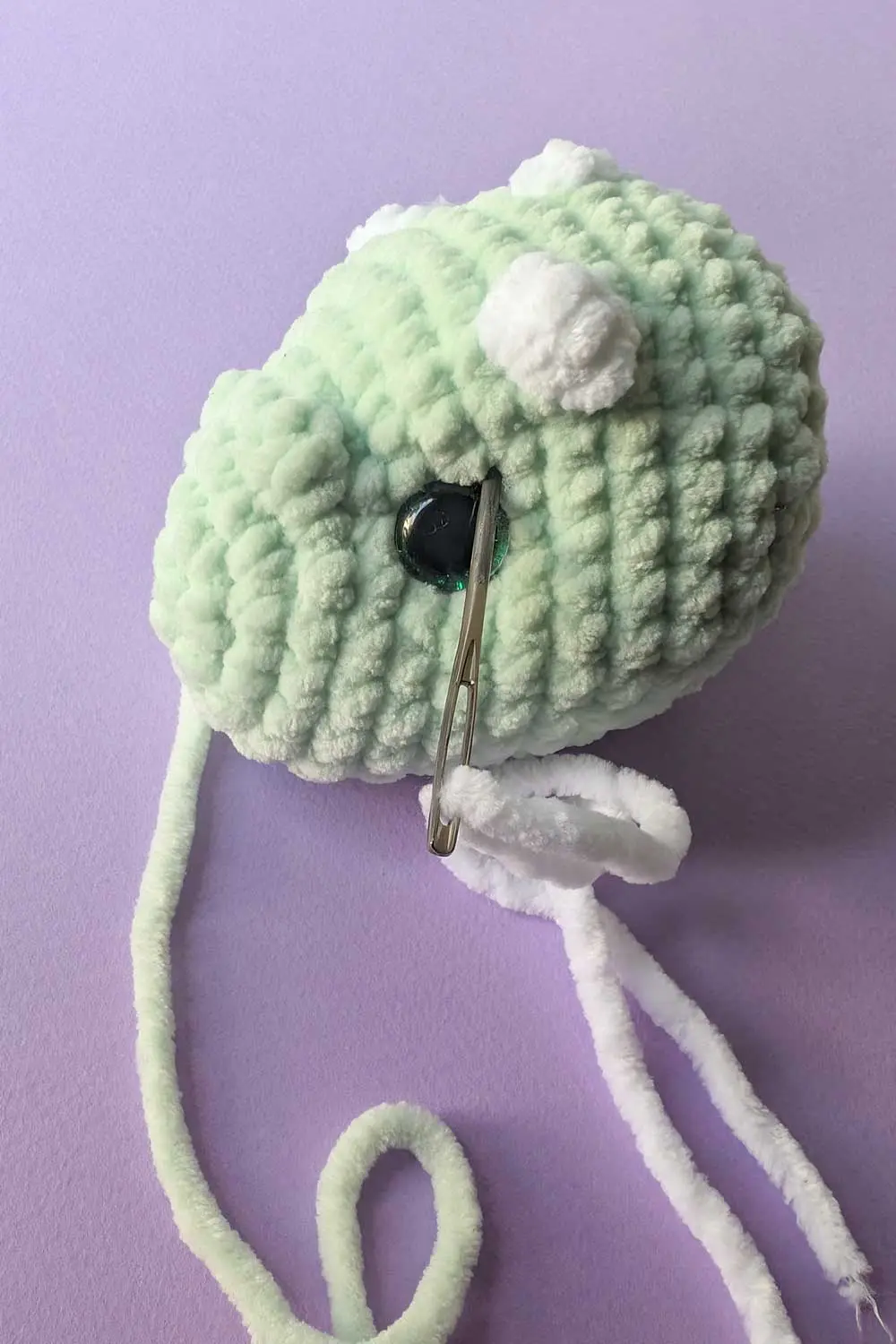 Crocheted dinosaur head in progress embroidery instructions