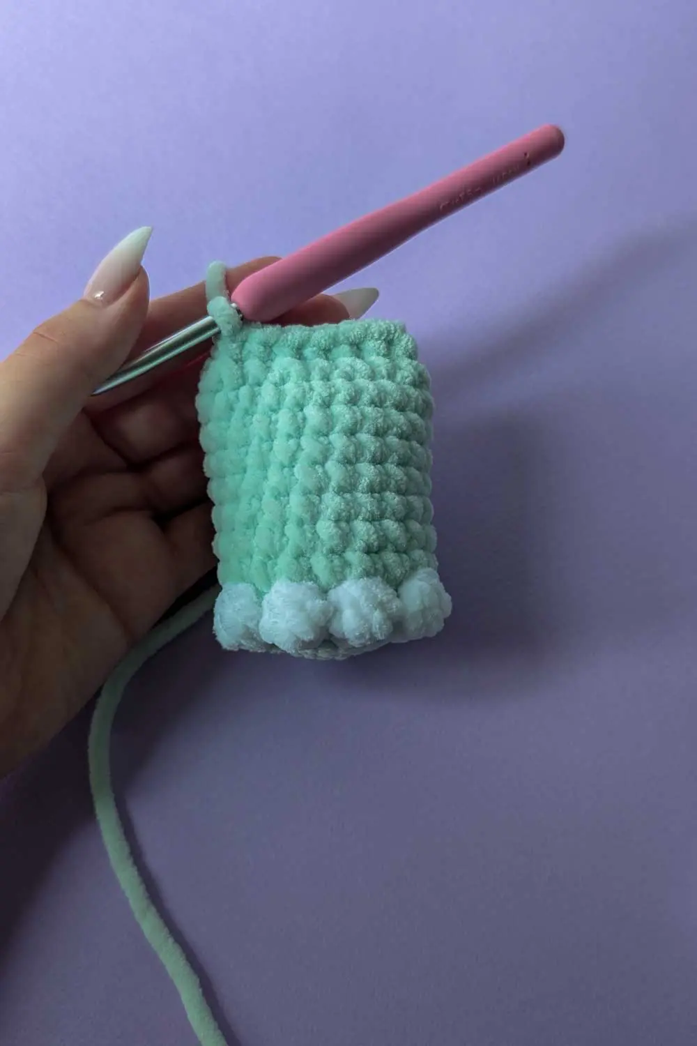 Crocheting a mint green plush piece with bobble stitches