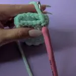 Crocheting a mint green plush piece with bobble stitches