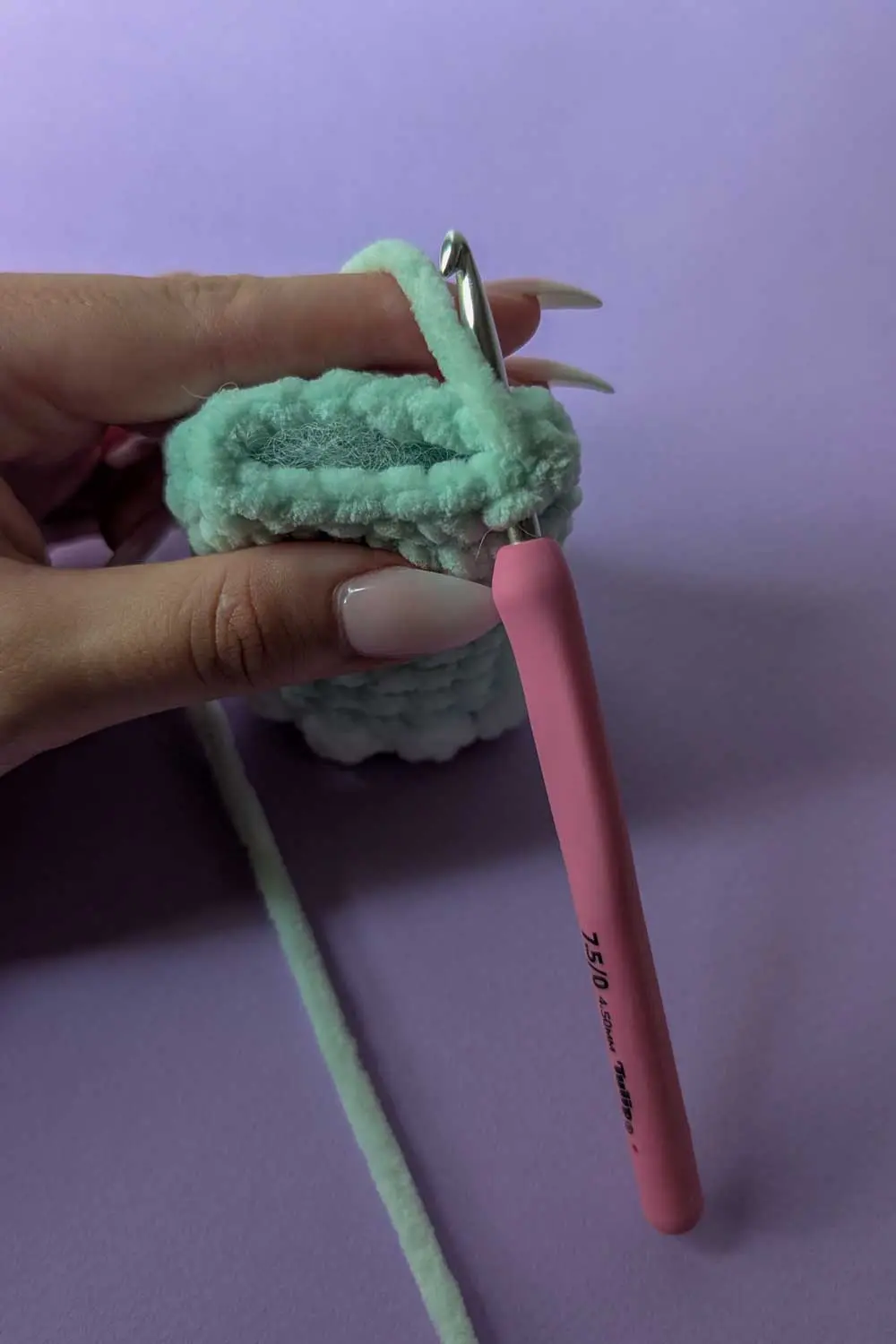 Crocheting a mint green plush piece with bobble stitches