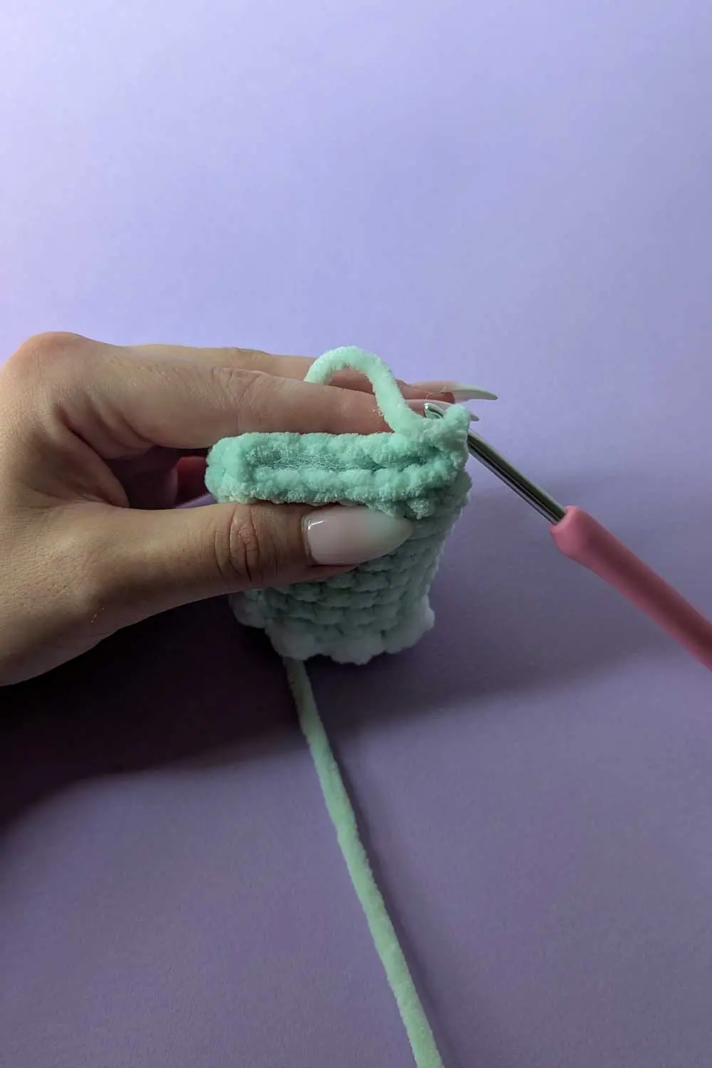 Crocheting a mint green plush piece with bobble stitches