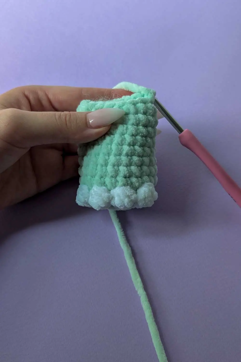 Crocheting a mint green plush piece with bobble stitches