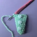 Mint green crochet dino tail with white crochet bobble stitches