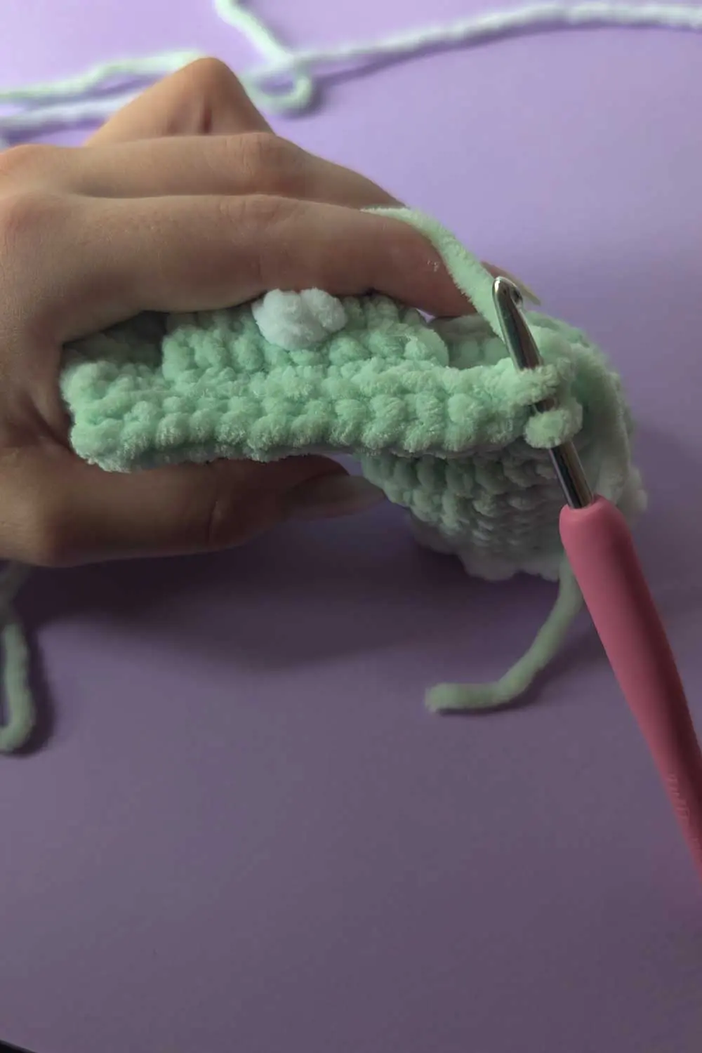 Crocheting a soft mint-colored dinosaur lovey