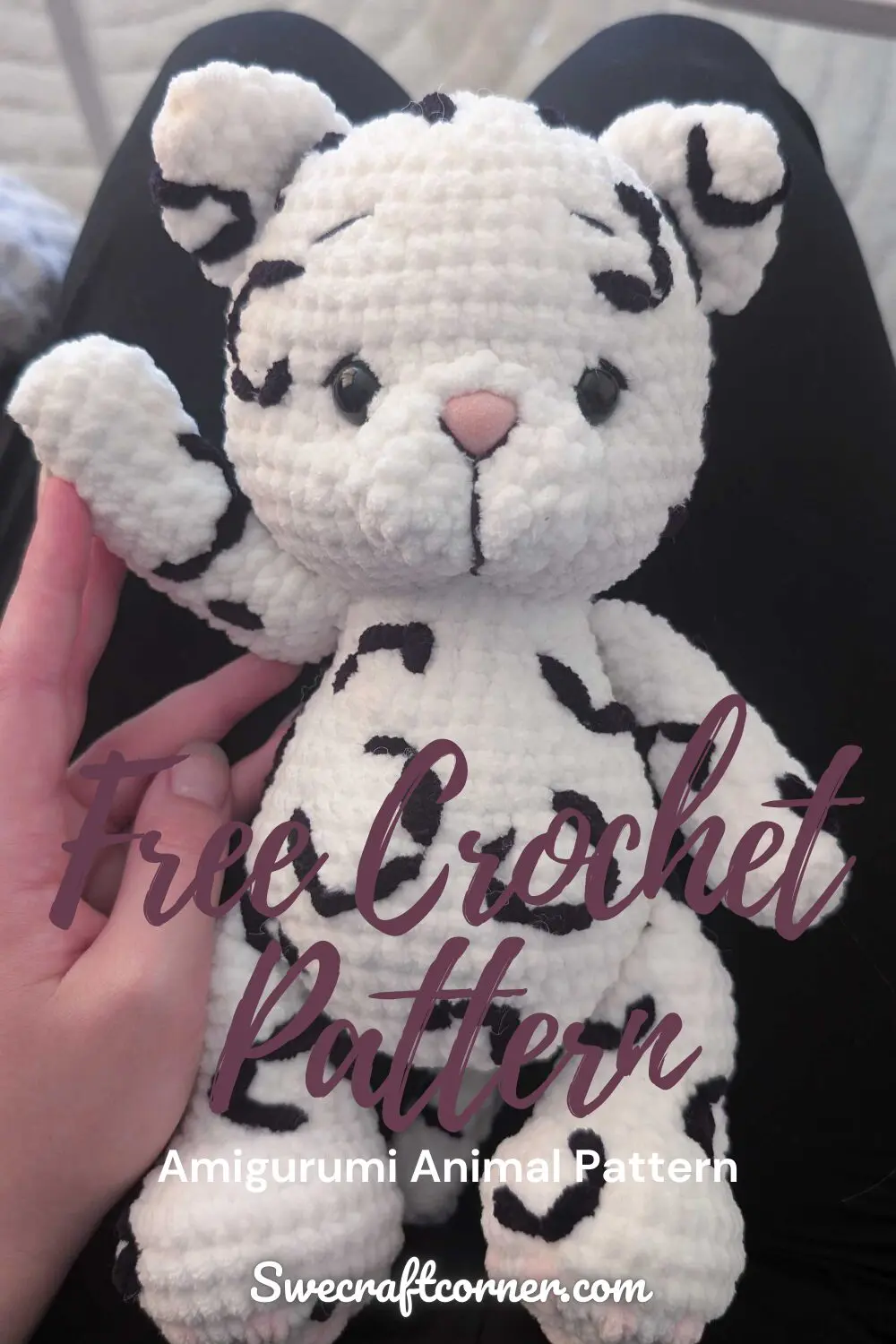 Crocheted snow leopard plush toy