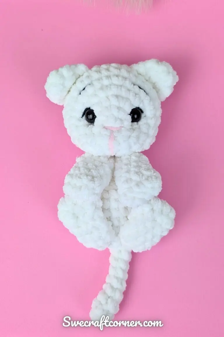 Cute kitten plush free crochet pattern White crocheted cat plushie on pink