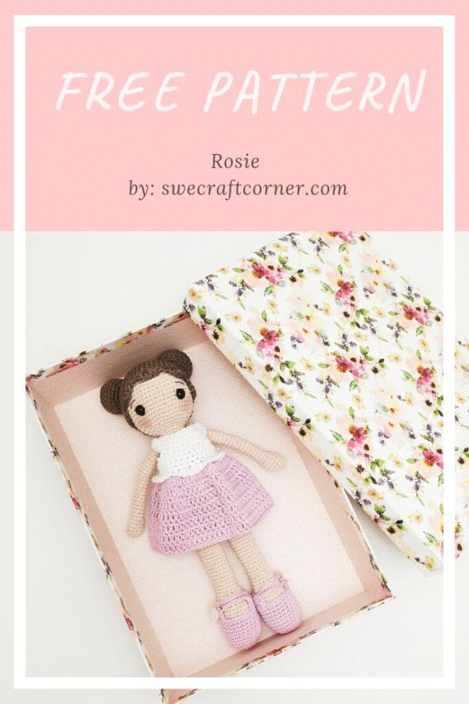 Open floral box with a handmade amigurumi doll inside, wearing a white top, pink skirt, and matching shoes. FREE PATTERN text above and a link to swecraftcorner.com for the Rosie doll crochet pattern.