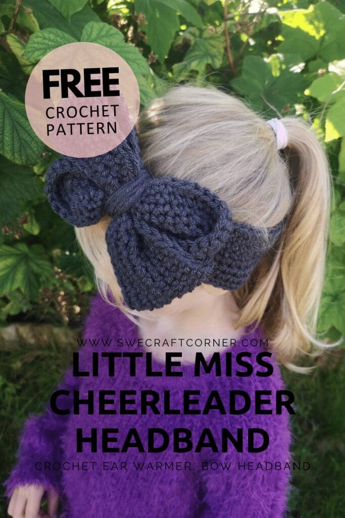 A young child with blonde hair wears a chunky, dark crochet headband with a large bow. Outdoors near green foliage, the image promotes a free crochet pattern for the Little Miss Cheerleader Headband.
