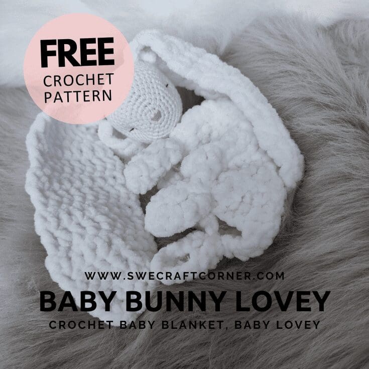 A soft, white crochet chenille lovey baby bunny lies on a fluffy grey surface. Text offers a free crochet pattern and describes the item as a crochet baby comfort blanket and baby lovey from swecraftcorner.com.