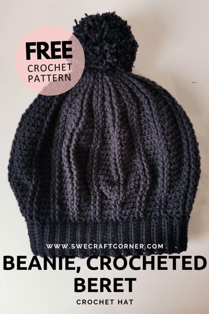 A black crochet beanie with a pom-pom is displayed on a light surface. Text on the image reads “FREE CROCHET PATTERN,” “BEANIE, CROCHETED BERET,” and “CROCHET HAT.” Perfect for those seeking a cozy, handmade crochet hat.