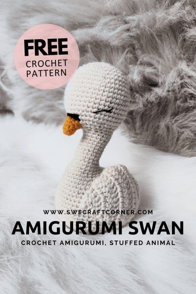 A crocheted amigurumi swan with a yellow beak and closed eyes sits on a soft, fluffy surface. Text reads: FREE CROCHET PATTERN, AMIGURUMI SWAN, crochet soft toys, and CROCHET AMIGURUMI STUFFED ANIMAL.