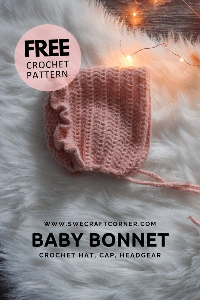 A pink crocheted baby bonnet with ruffled edge, perfect for baby crochet clothes, is displayed on a white fur surface beside string lights. Text reads FREE crochet pattern, www.swecraftcorner.com, and BABY BONNET crochet hat, cap, headgear.