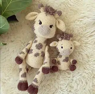 Crocheted giraffes, one large, one small.
