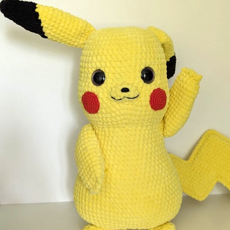 Yellow crochet Pikachu plush toy waving