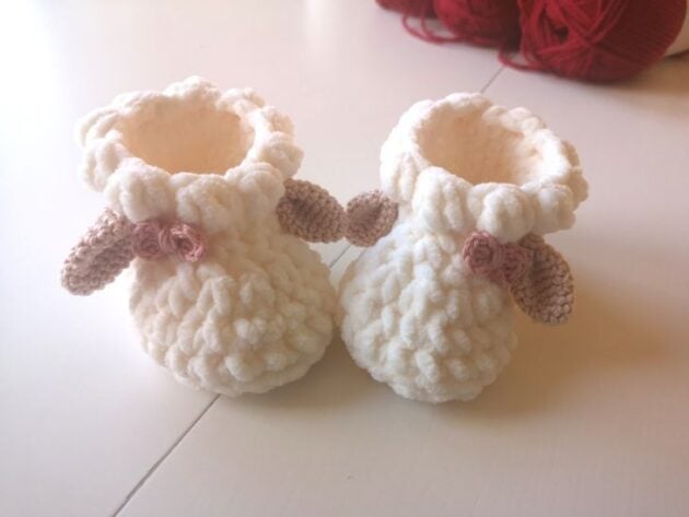 FREE Crochet patterns and crafts image showing baby booties crocheted in a soft chenille yarn with cute lamb ears