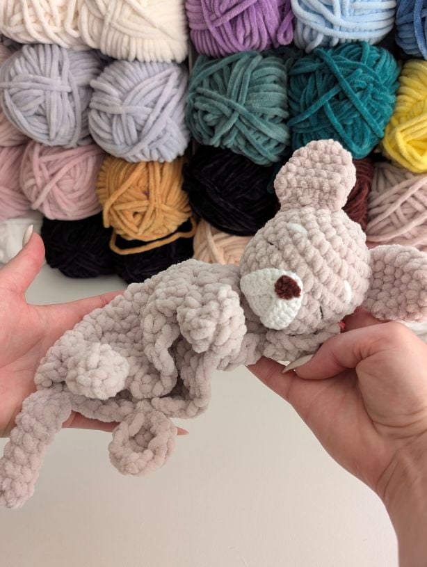 FREE Crochet patterns and crafts image of hands holding a bulldog baby lovey free crochet pattern in the article