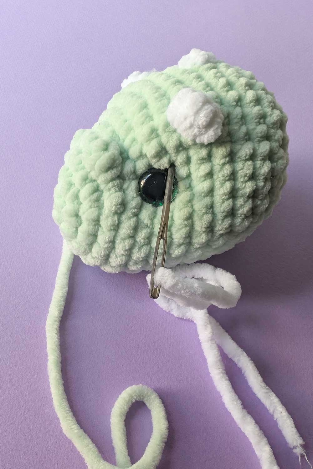Crocheted dinosaur head in progress embroidery instructions