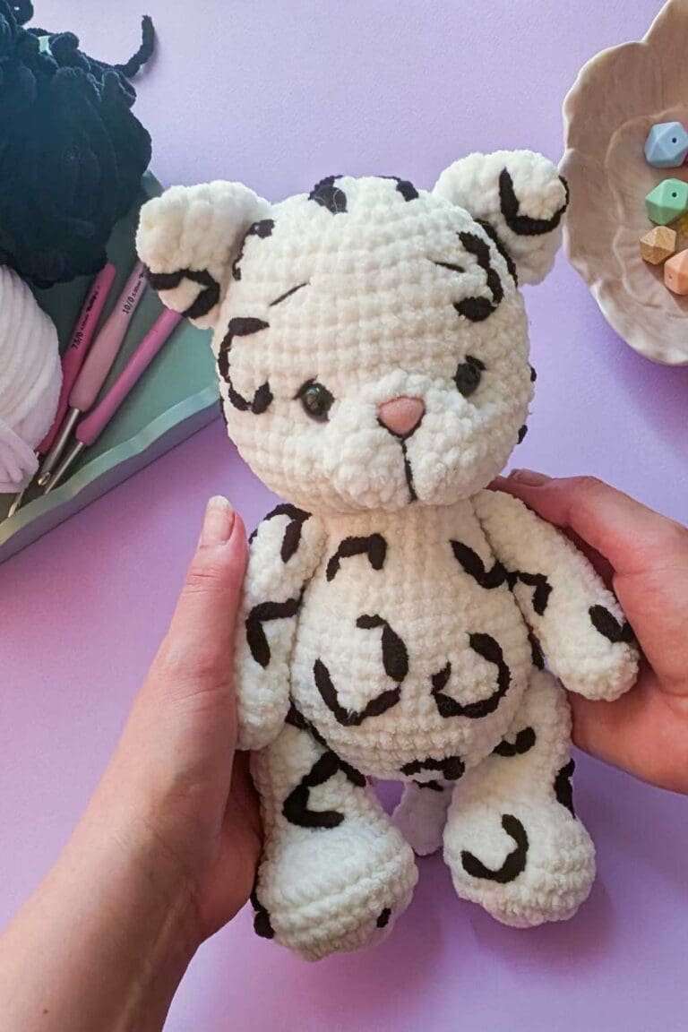 Crocheted plush snow leopard toy