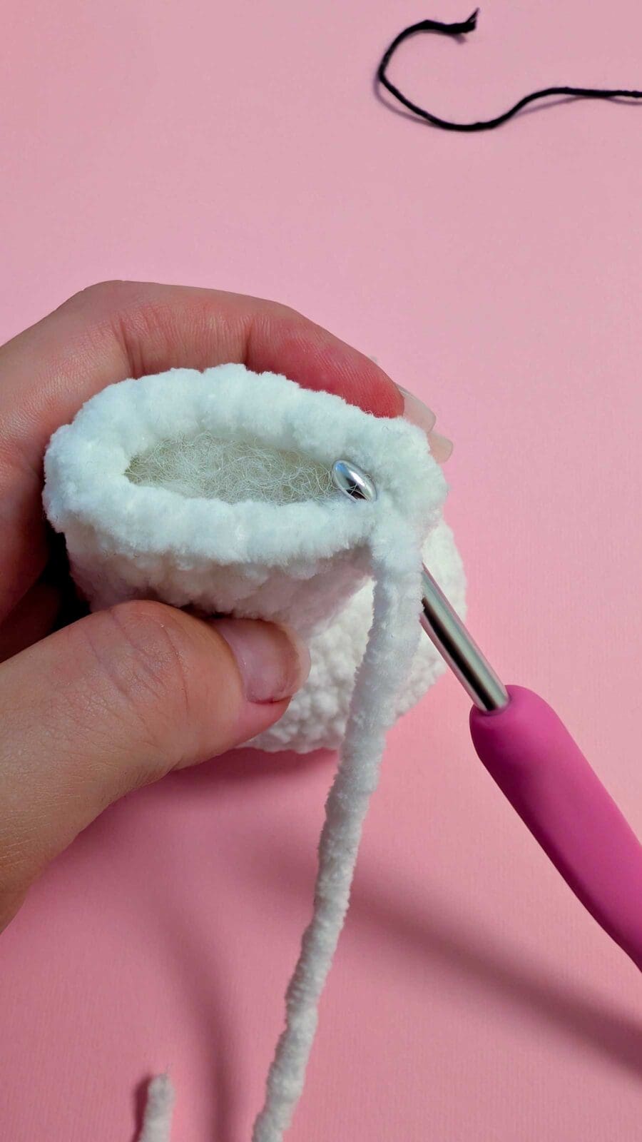Hand holding white crochet piece