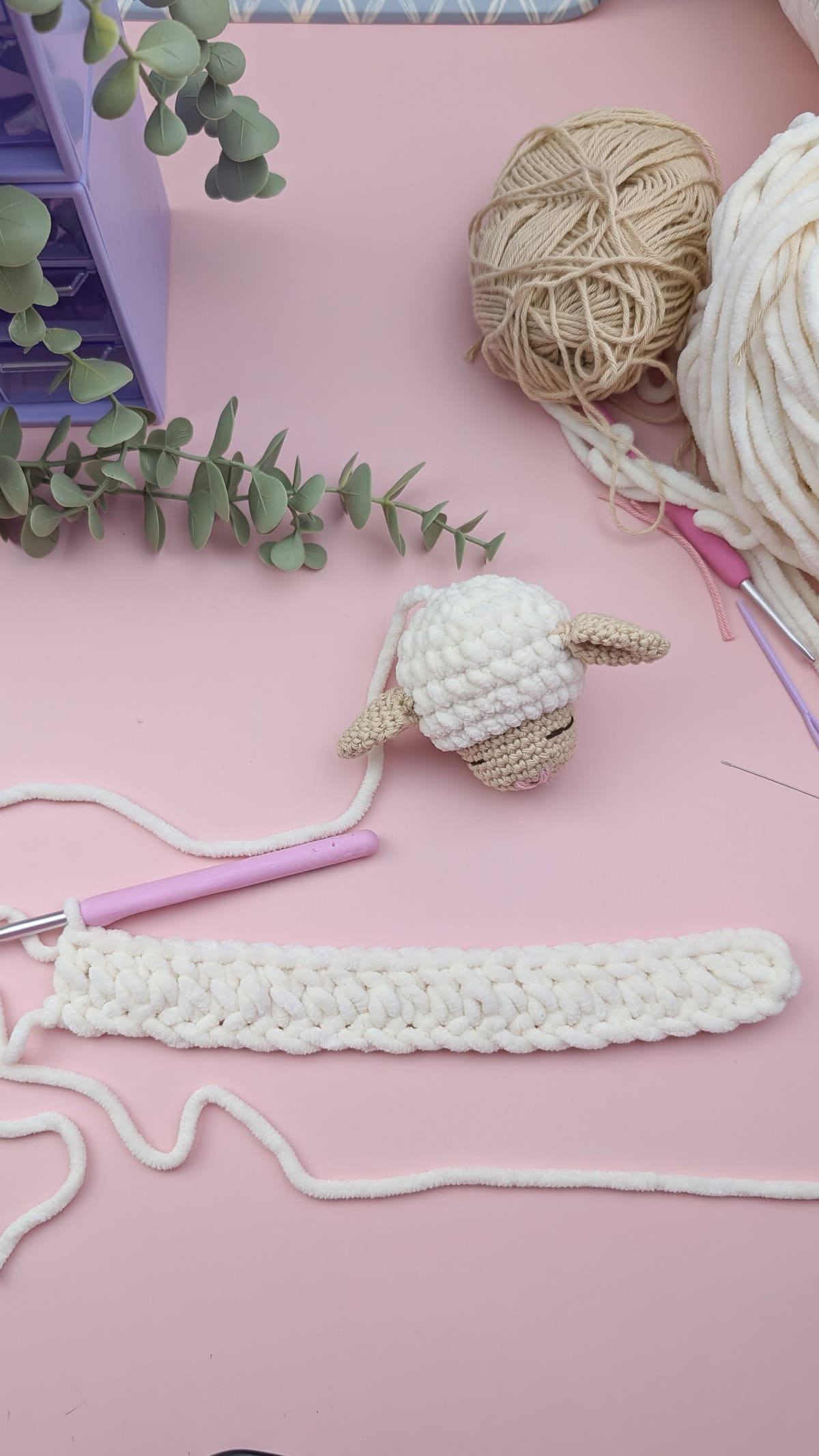 start of the body for the lovey in white chenille yarn, the lovey head is above