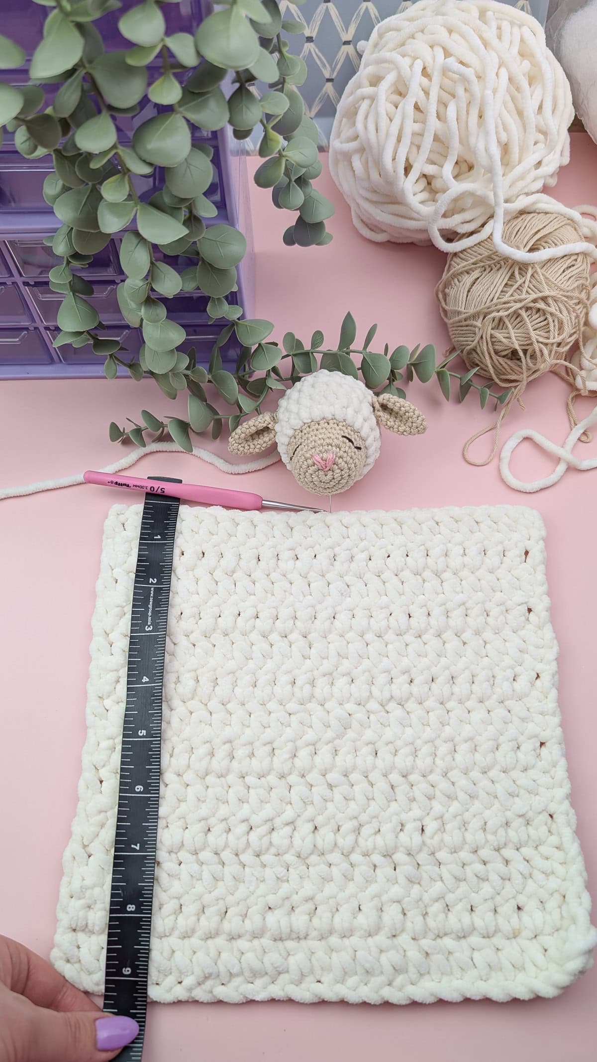 finished lamb head and finished lovey body with a measuring tape