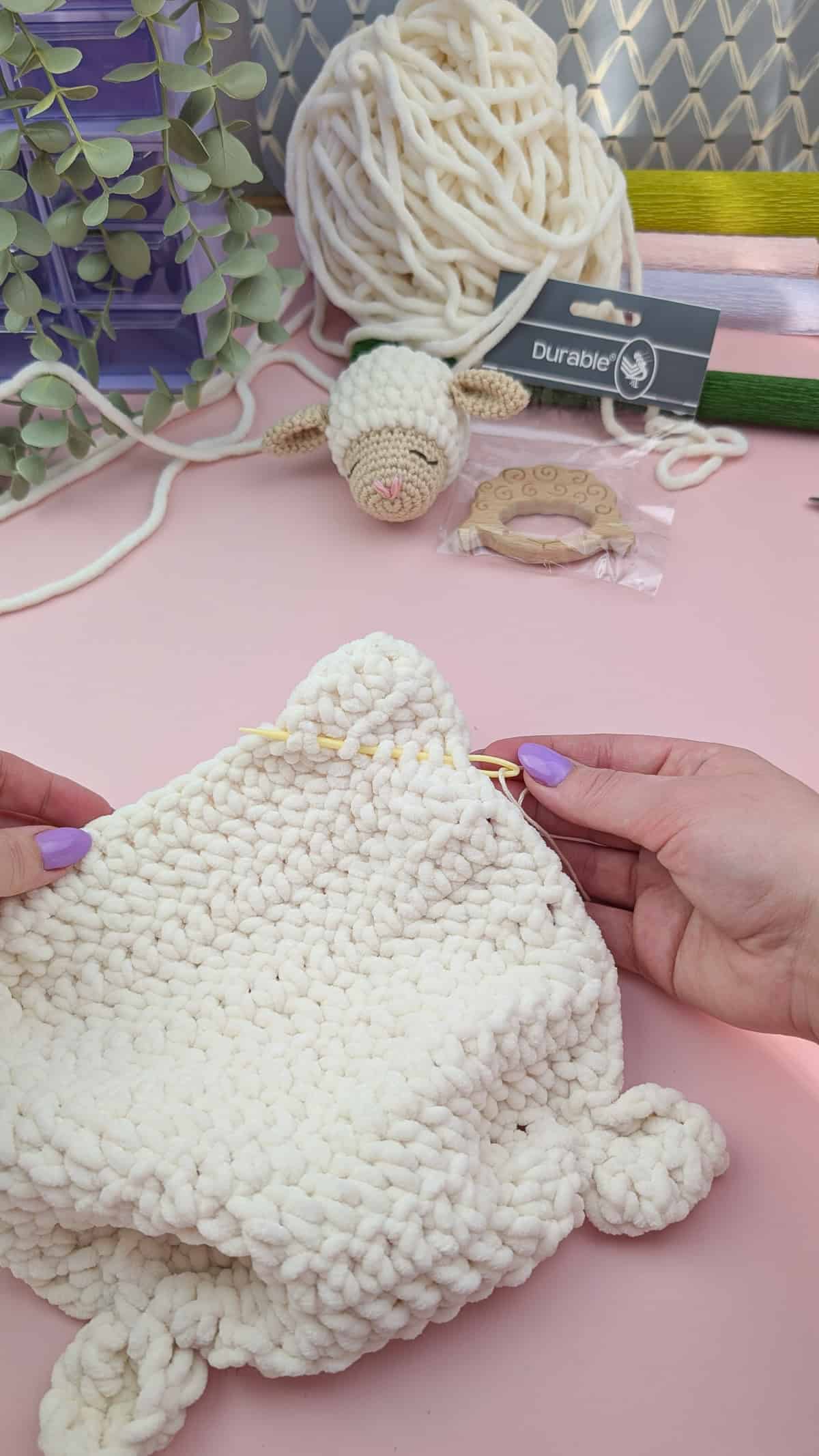 making feet of the lovey in each corner of the white chenille yarn body