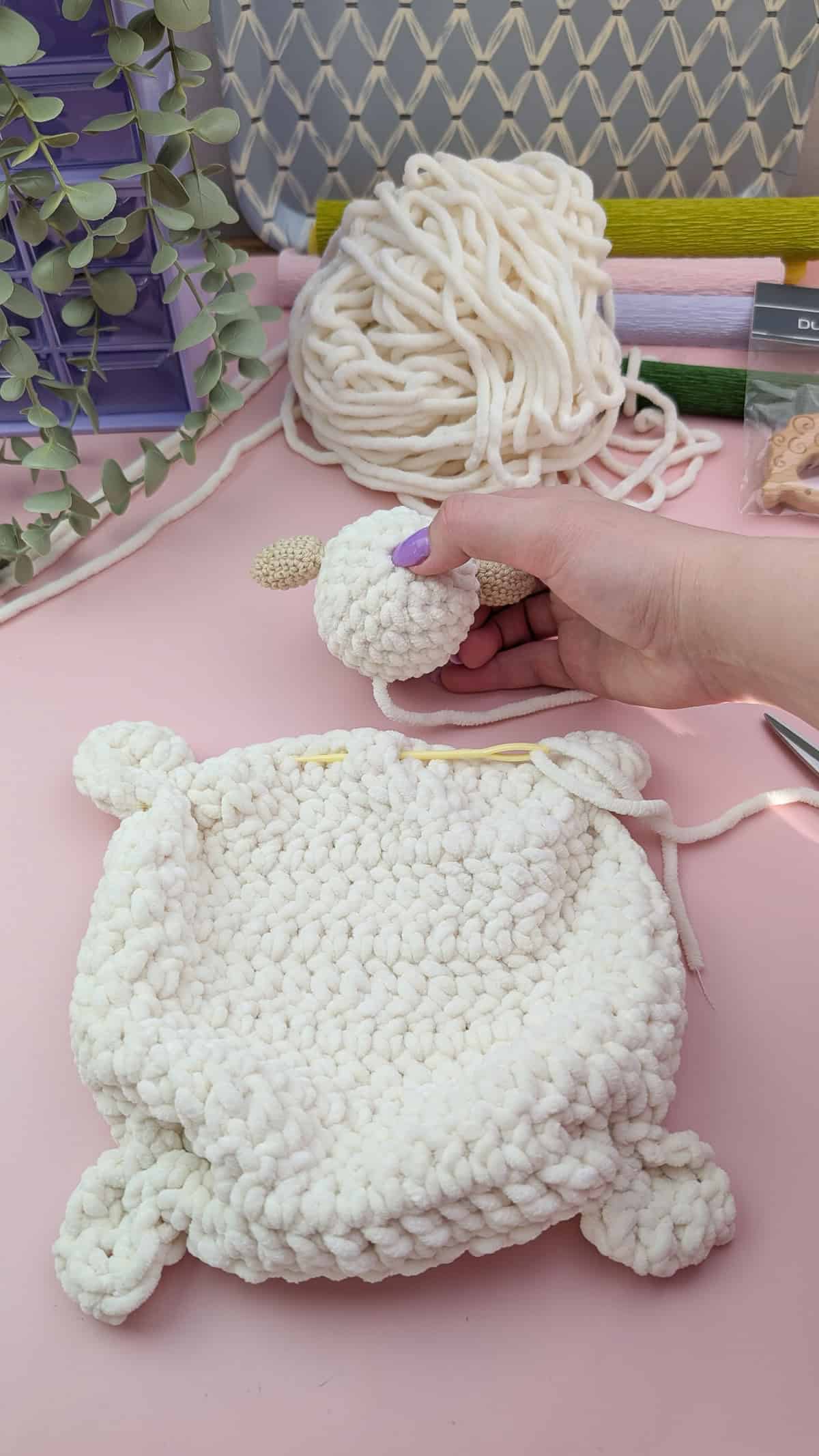 white chenille yarn lamb lovey head and body being assembled